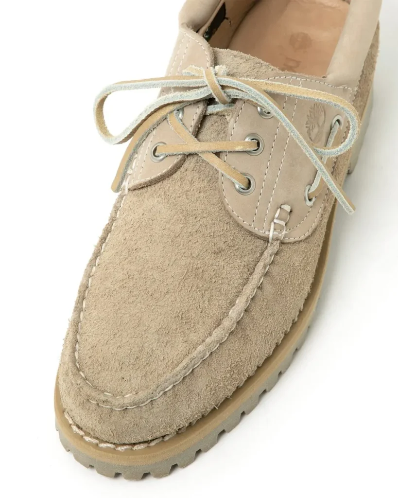 Macro shot of the Timberland x nonnative 3EYE CLASSIC TAUPE highlighting handsewn moccasin stitching, suede grain, and natural taupe tone