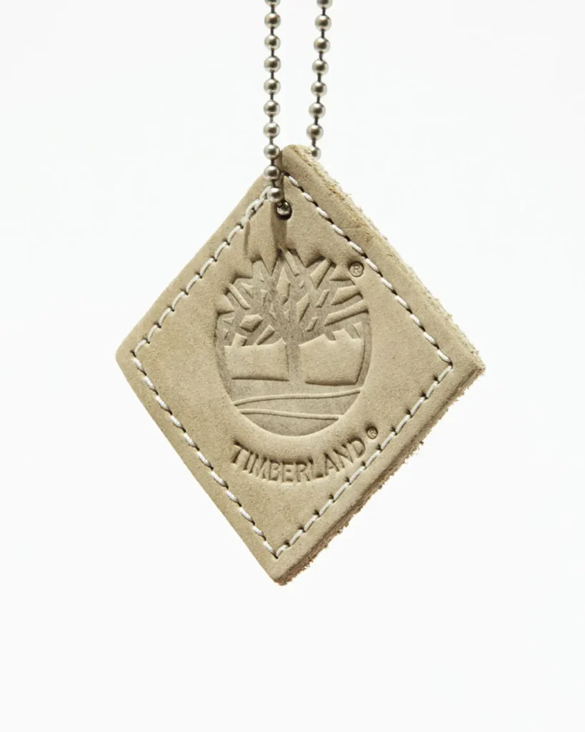 Premium suede hang tag with embossed Timberland tree logo and branding, created exclusively for the Timberland x nonnative collection