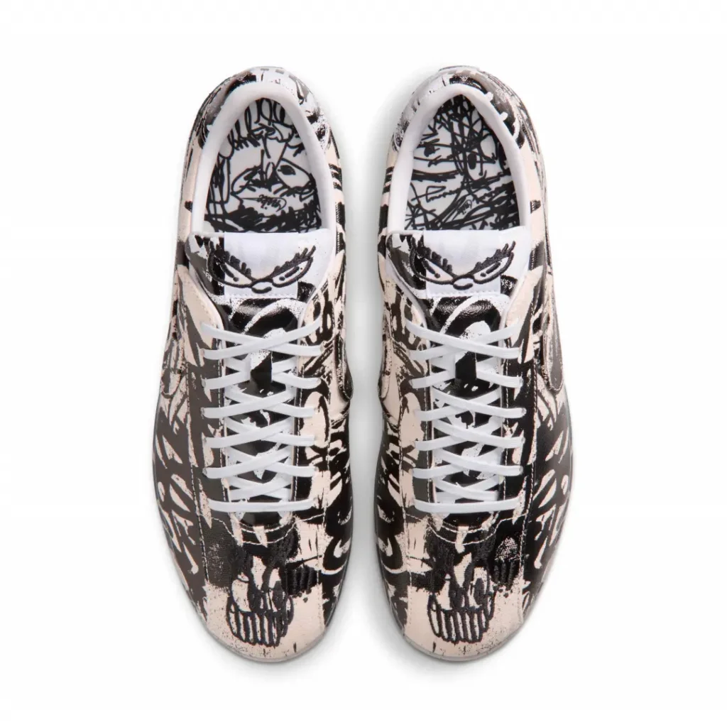 Top-down view of the sneakers highlighting symmetrical artwork placement, graphic tongue detailing, and illustrated footbed