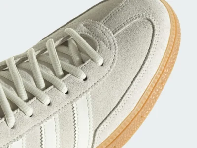 Detailed close-up of the forefoot area of the Messi Handball Spezial “Ivory,” showcasing soft suede overlays, tonal stitching, cream laces, and the iconic adidas Three Stripes above a gum sole