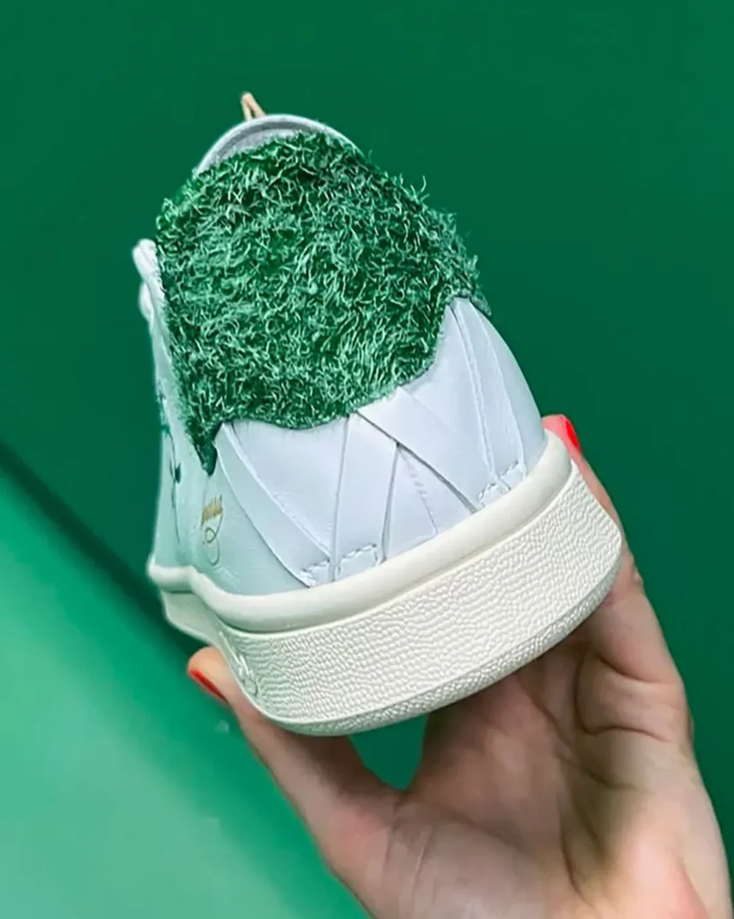 Close-up rear view of the collision highlighting the textured green heel construction, cream heel tab with Chavarria rose branding, geometric leather overlays, and vintage-style off-white mid