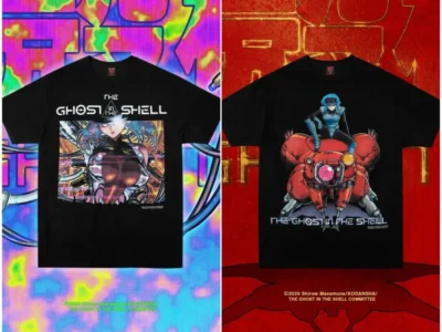 Two black Ghost in the Shell graphic T-shirts are displayed side by side. One features a futuristic cybernetic character surrounded by cables and neon circuitry, while the other shows a blue-haired character seated atop a red spider-like tank. Vibrant cyberpunk-inspired backgrounds frame both design