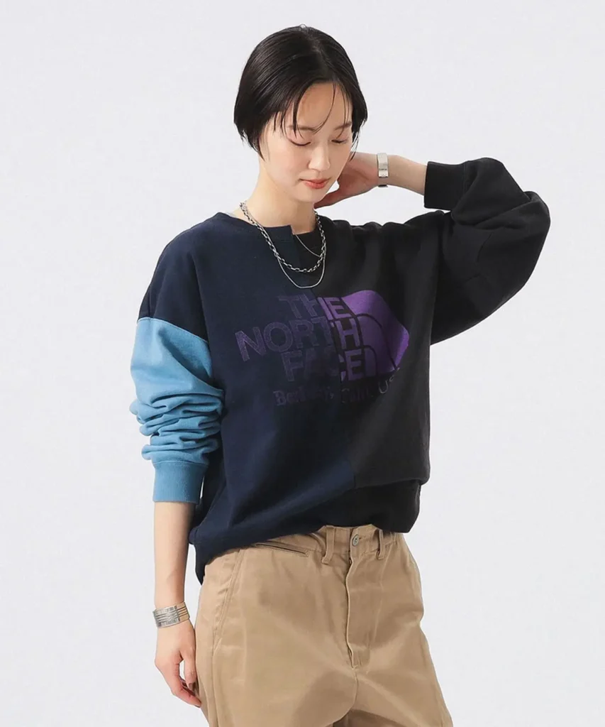 Navy and blue The North Face oversized sweatshirt featuring tonal logo artwork, color-block sleeves, and relaxed modern sil