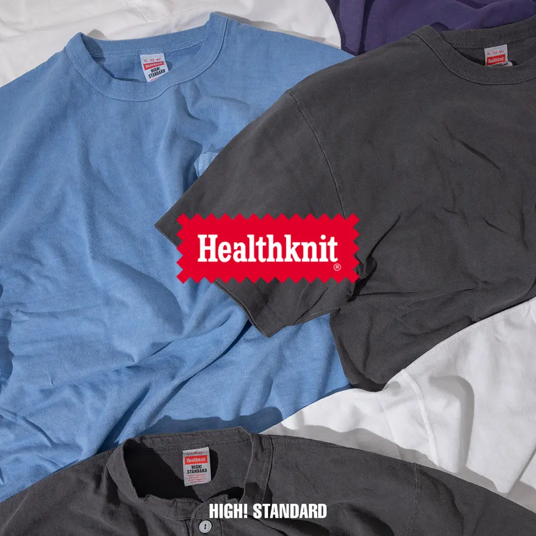 Healthknit HIGH! STANDARD heavyweight cotton T-shirts in washed blue, charcoal gray, white, and purple arranged together, showcasing the brand's vintage-inspired essentials collection.