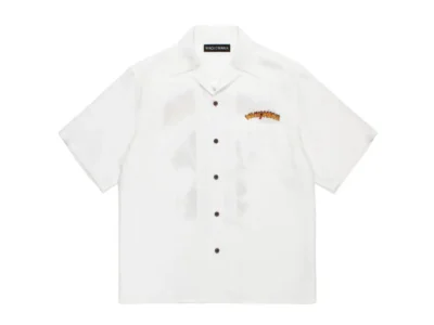 Front view of a white WACKO MARIA short-sleeve open-collar shirt with understated logo detailing on the chest and classic mid-century style