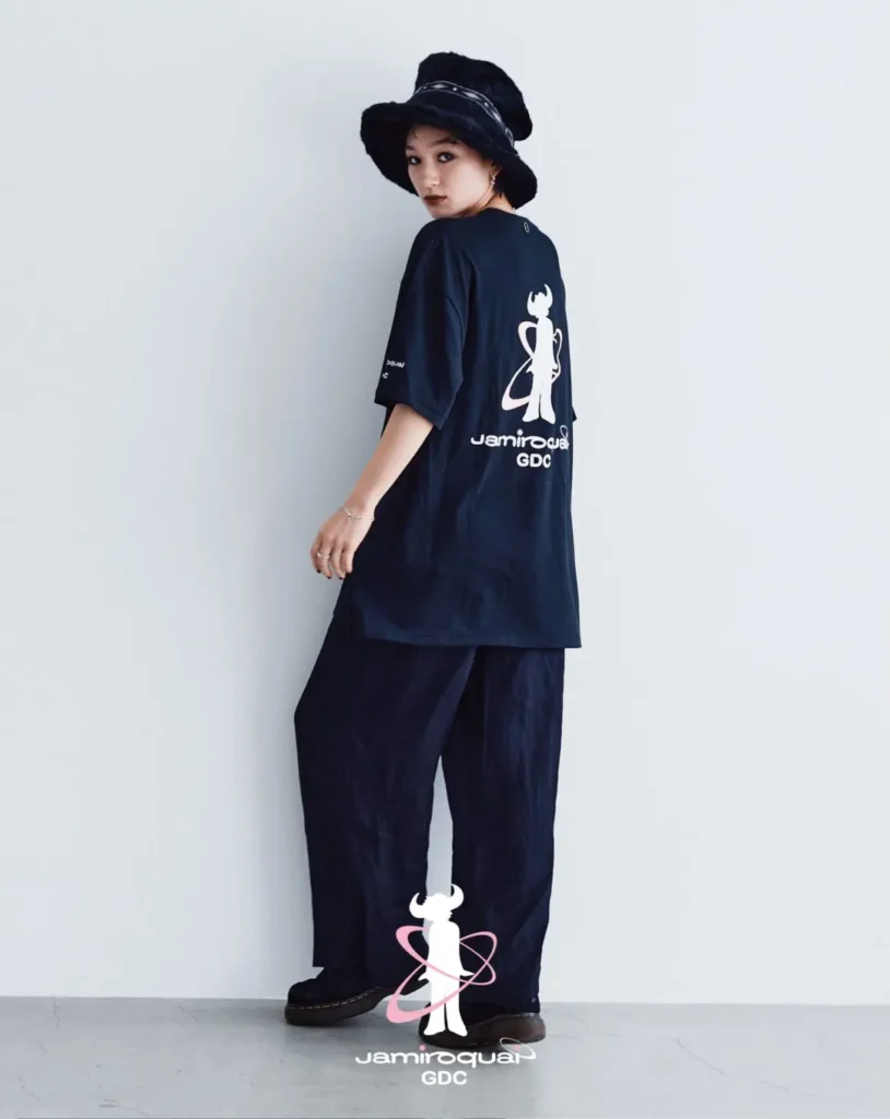Editorial image featuring a model posing with arms raised, emphasizing the oversized silhouette and large buffalo-man artwork on the back of the black collide Tee