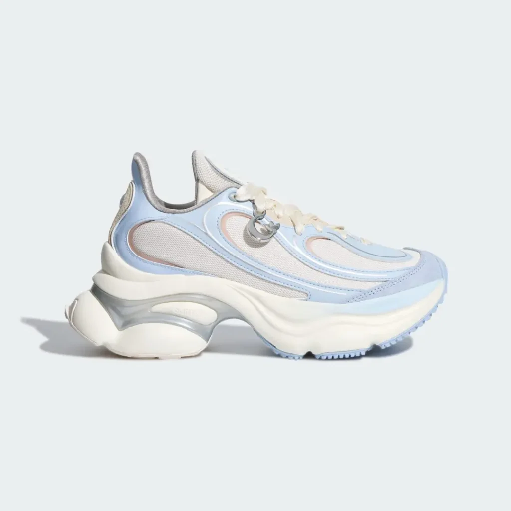 Side profile of a chunky adidas Originals shoe featuring pastel blue synthetic overlays, white mesh panels, cream laces, and a sculpted oversized sole with translucent silver detai