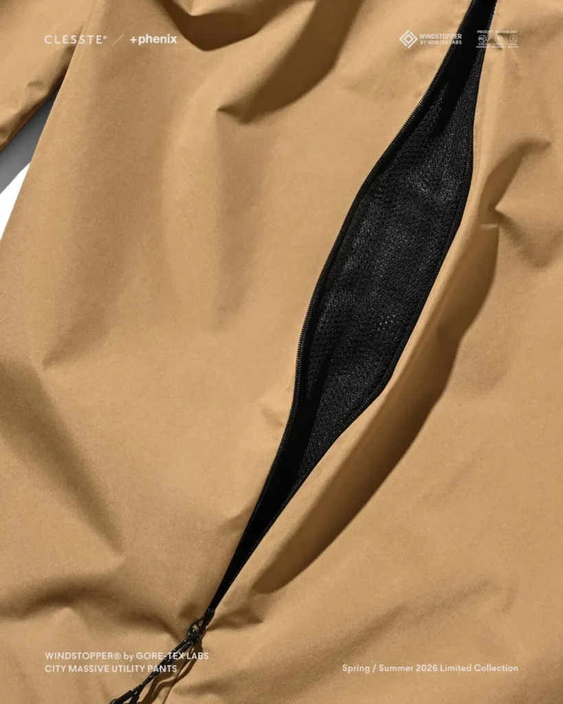 Close-up of beige CITY MASSIVE UTILITY PANTS side ventilation system with black mesh lining visible through an opened zipper vent