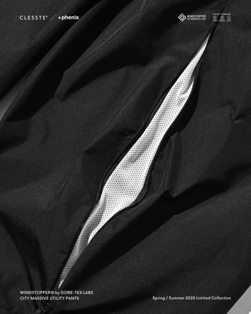 Close-up of side ventilation zipper on black CITY MASSIVE UTILITY PANTS, revealing breathable mesh lining beneath the WINDSTOPPER shell fabric