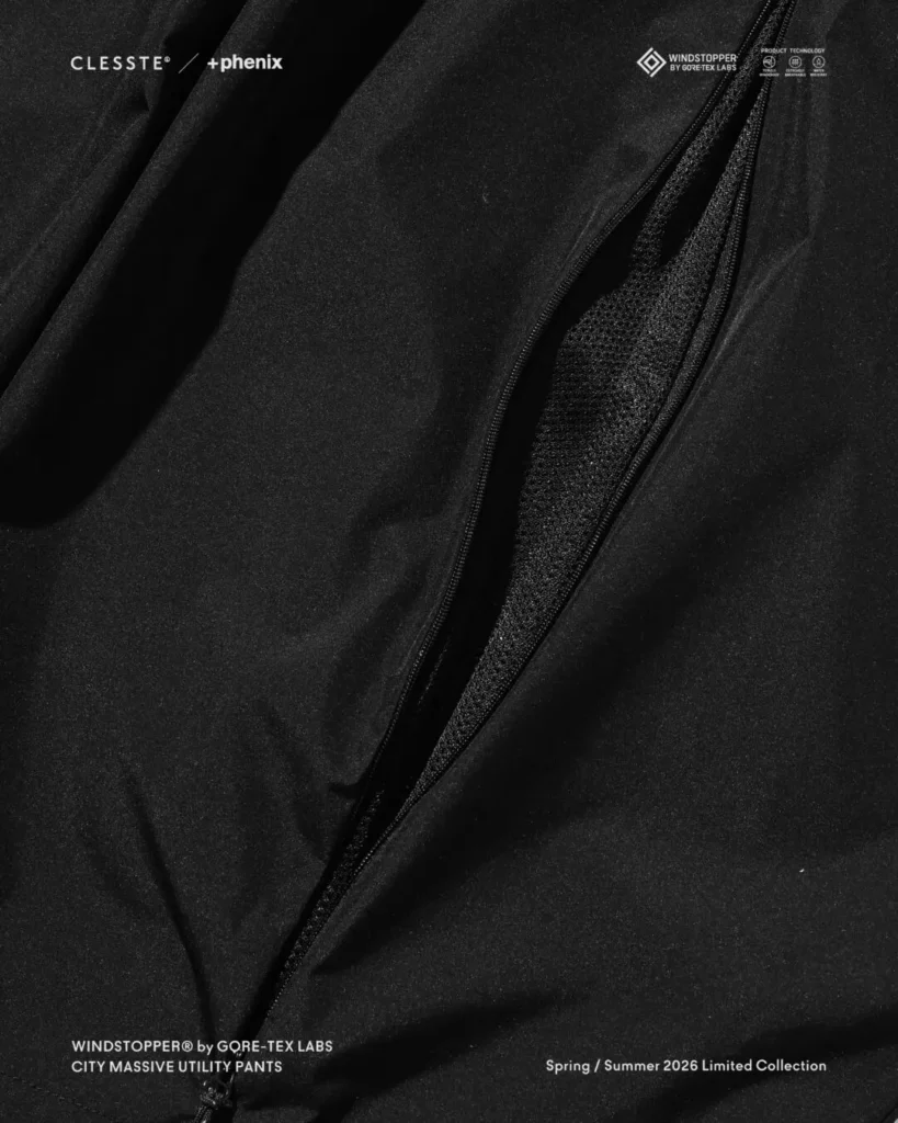 Detailed close-up of black utility pants with opened side vent, exposing black mesh interior for enhanced airflow and temperature regulation