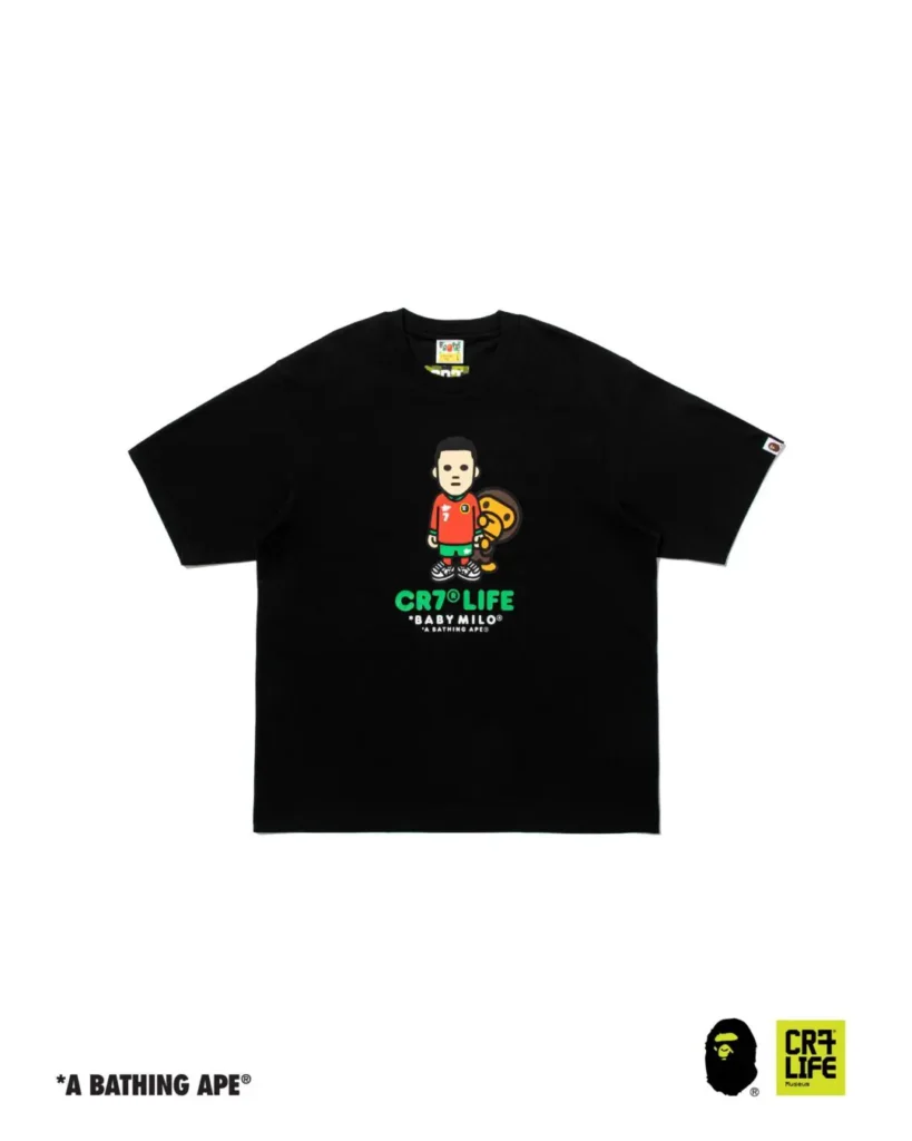 Black A BATHING APE x CR7 LIFE Tee featuring a central Baby Milo and Cristiano Ronaldo character graphic with vibrant green CR7 LIFE branding on the front