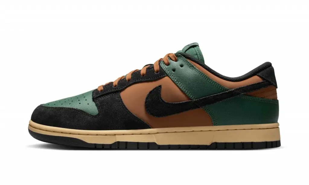 Medial side profile of the green and brown Nike Dunk Low displaying green heel and forefoot panels, brown midfoot, black suede overlays, black Swoosh, and cream mid