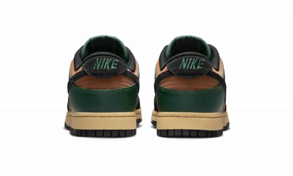 Rear heel view of the green and brown Nike Dunk Low featuring green embroidered Nike branding on black suede heel tabs, green heel overlays, brown upper accents, and cream mid