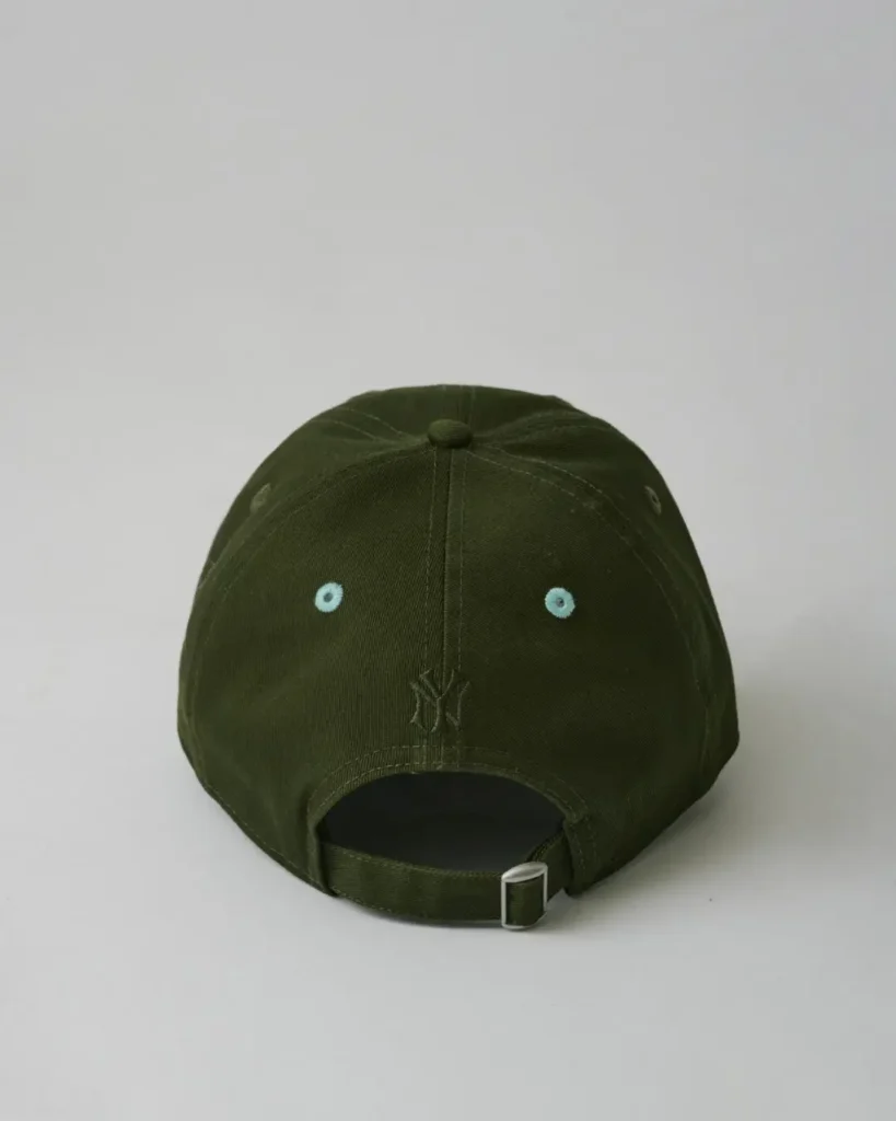 Rear view of the olive Yankees cap with matching mint eyelets, tonal rear logo embroidery, and adjustable fabric strap