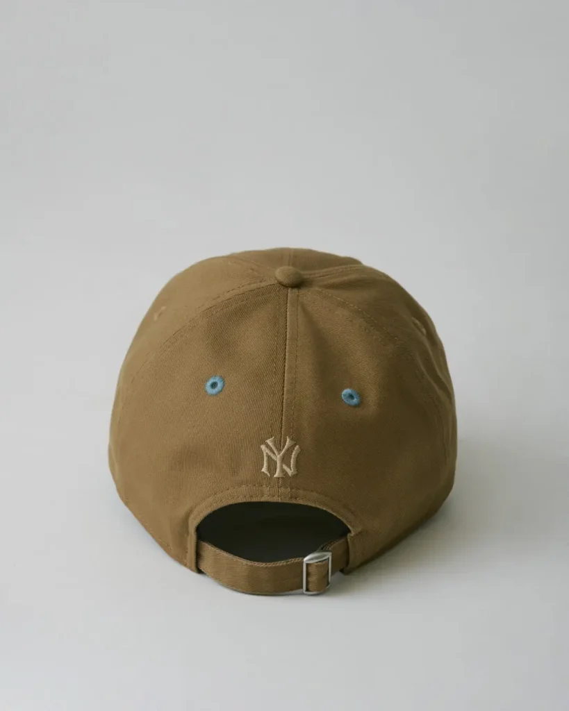 Back view of the khaki Yankees cap with matching blue eyelets, tonal rear logo embroidery, and adjustable strap closure
