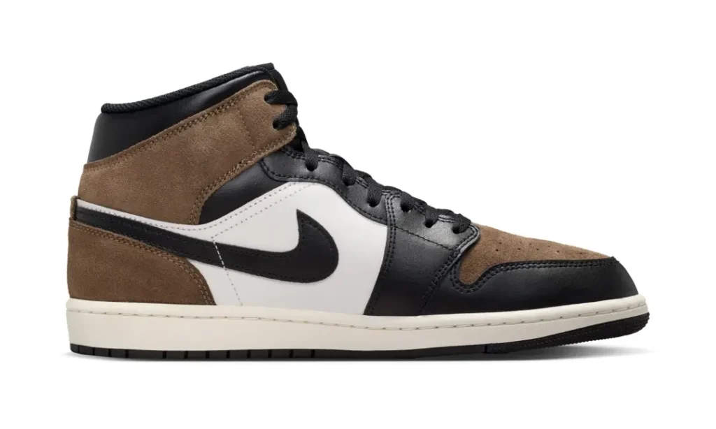 Medial side view of the Air Jordan 1 Mid highlighting textured brown suede overlays, smooth black leather construction, and a vintage-inspired sail mid