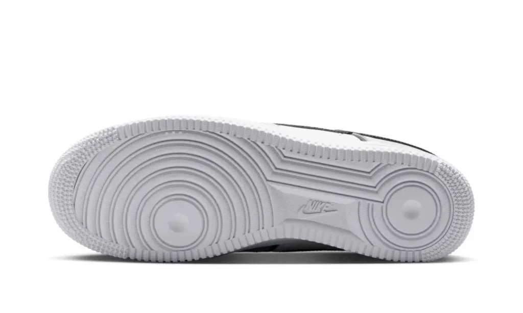 Bottom view of the Nike Air Force 1 Low showcasing the all-white rubber outsole with the iconic concentric-circle traction pattern and Nike branding at the mid