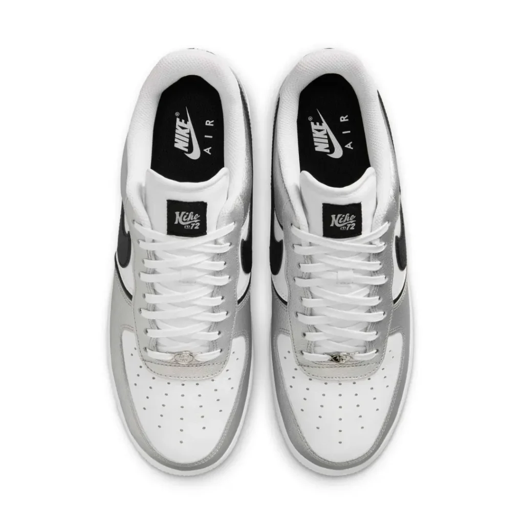 Top-down view of the Nike Air Force 1 Low displaying white laces, black Nike Air insoles, retro tongue labels, and metallic AF1 lace dubrae