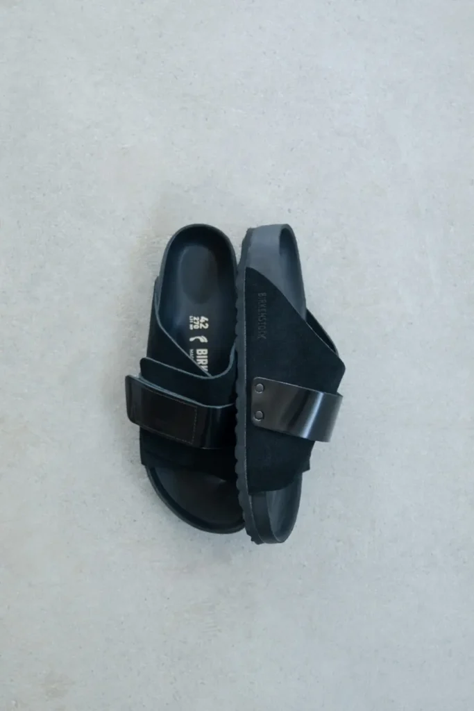 Top-down view of Birkenstock for Biotop sandals in black, featuring suede crossover panels, smooth leather strap detailing, and molded footbed