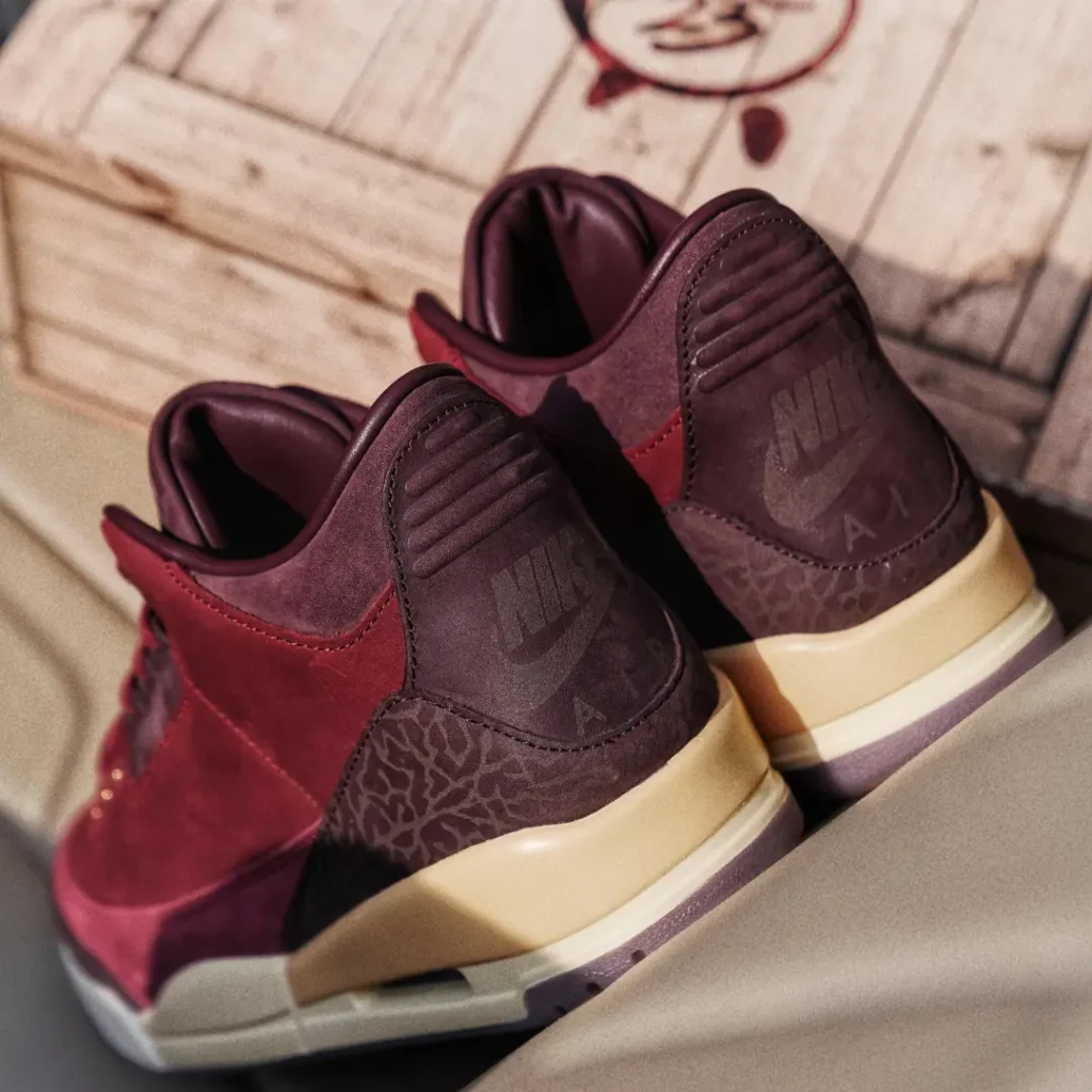 Rear angle view of the Air Jordan 3 Low BIN23 highlighting embossed Nike Air branding, tonal elephant-print overlays, padded collars, and vintage-inspired cream midsole