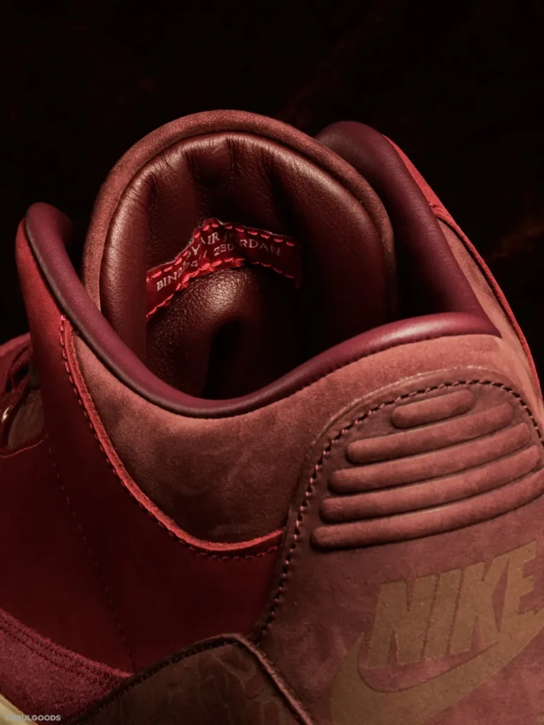 Interior view of the Air Jordan 3 Low BIN23 showcasing quilted burgundy lining, premium leather padding, and hidden BIN23 craftsmanship details beneath the collar