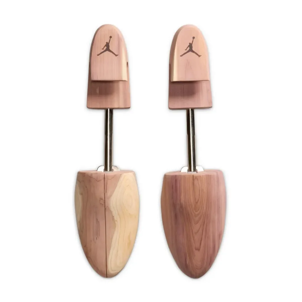 Pair of cedar wood shoe trees engraved with the Jumpman logo, included as part of the Air Jordan 3 Low BIN23 premium collector’s package