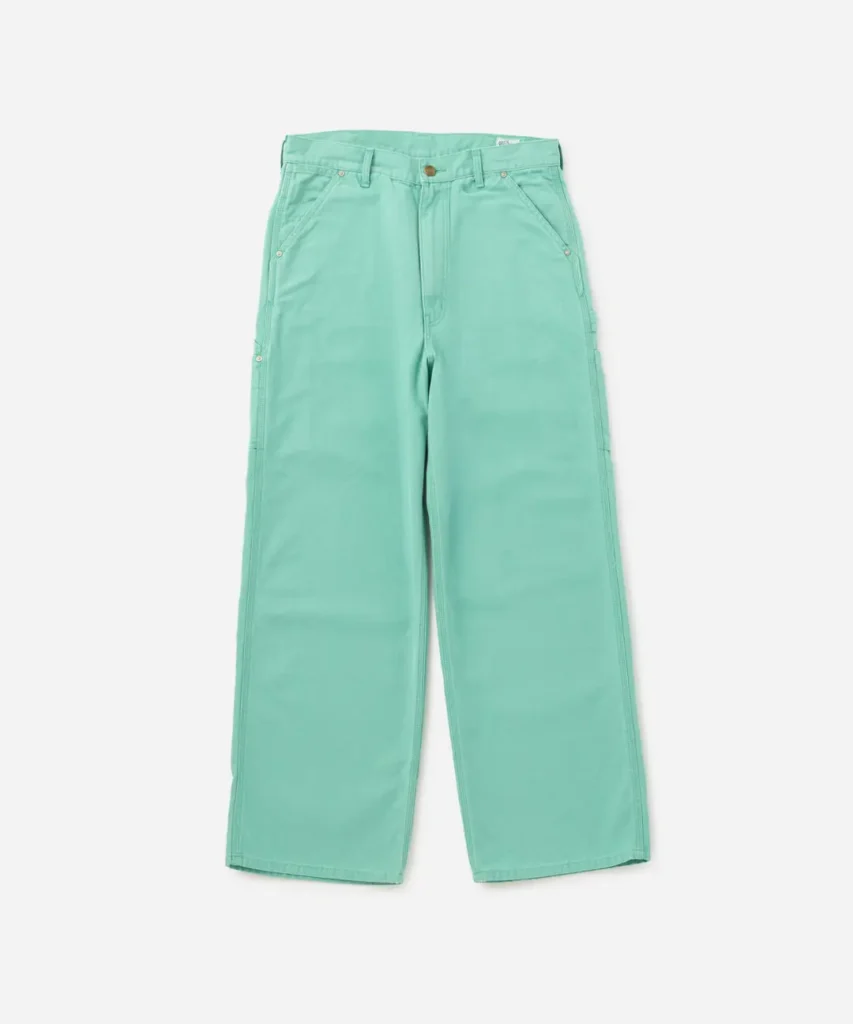 Mint-green carpenter pants with oversized utility pockets and loose-fitting construction, designed for a modern workwear aesthetic