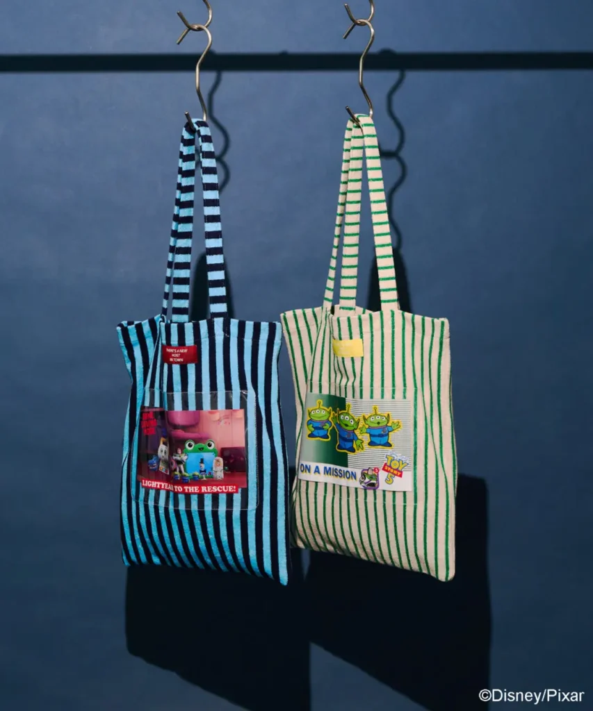 Striped Toy Story tote bags featuring Buzz Lightyear rescue graphics and Little Green Alien patches with playful collectible-inspired detail