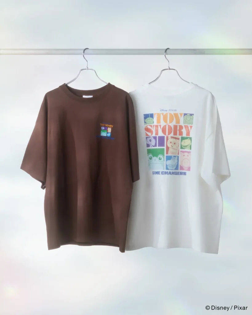 Buzz Lightyear-inspired graphic T-shirts in washed charcoal and vibrant pink featuring futuristic artwork and “Buzzworthy” typography