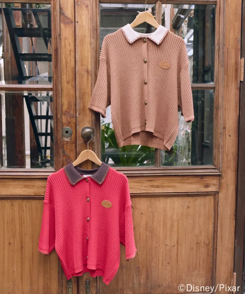 Earth Music & Ecology Toy Story knit cardigans featuring cowboy-inspired collars, textured construction, and subtle character detailing displayed against rustic wooden door