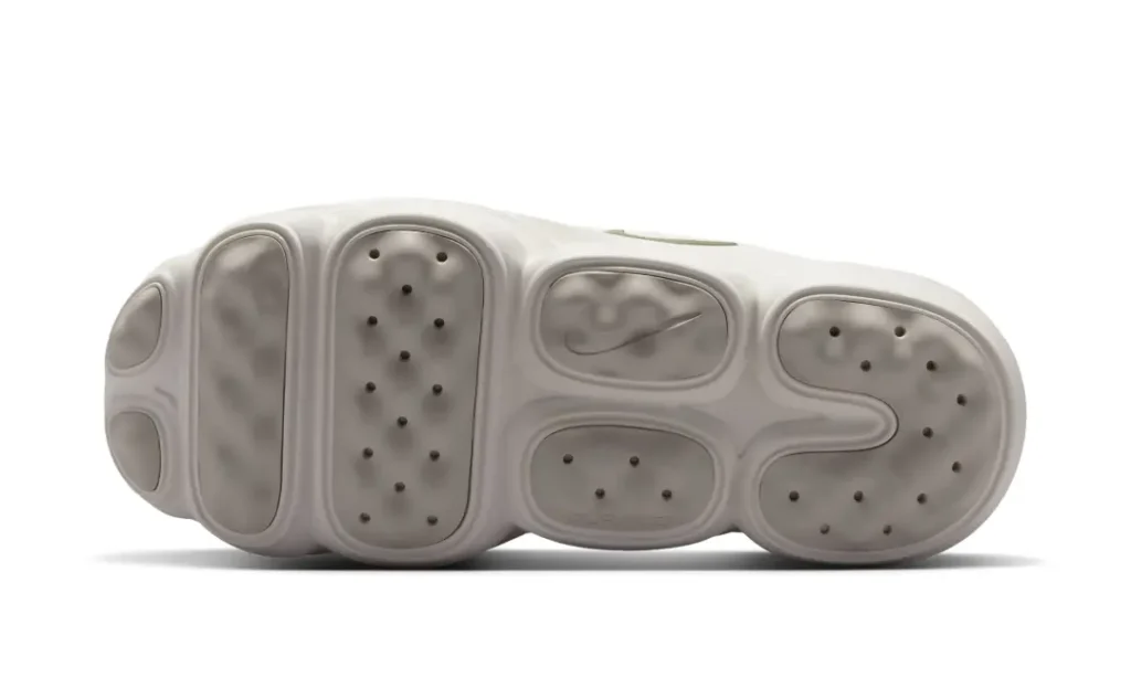 Outsole view of the Nike Motiva Suede displaying segmented traction zones, durable rubber pods, and a walking-oriented tread pattern