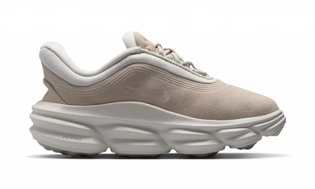 Medial side view of the Nike Motiva Suede highlighting the seamless suede upper, layered contours, and thick foam cushion sys