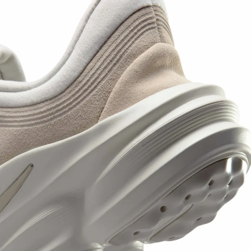 Macro view of the Nike Motiva Suede heel area showcasing layered suede paneling, sculpted foam midsole, and comfort-focused cushion architecture