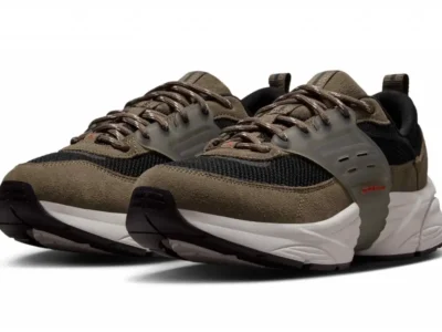 Pair of Jordan lifestyle runners shown in a three-quarter view, featuring olive-brown suede overlays, black mesh underlays, a translucent midfoot cage, and a chunky white sculpted midsole