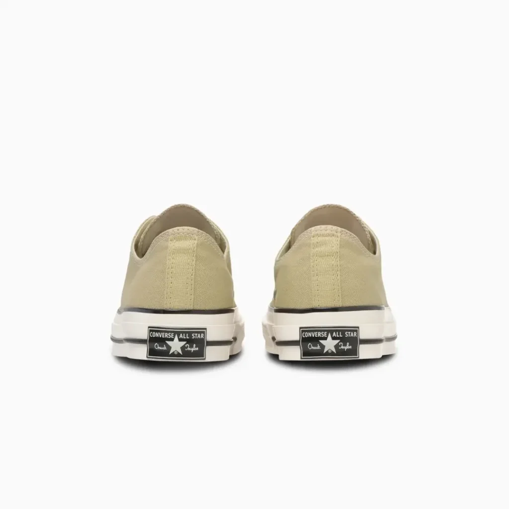 Rear view of beige Converse Chuck Taylor All Star low-top shoe showcasing the signature Converse All Star heel license plate, classic foxing stripe, and durable canvas upper