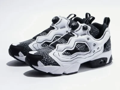 Angled pair shot of the Reebok Instapump Fury collection edition, emphasizing the contrast between the white overlays and black patterned base