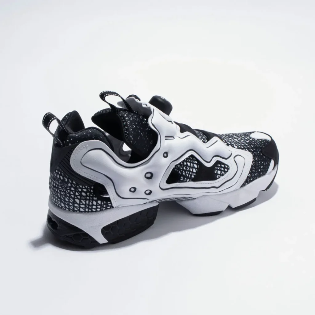ear three-quarter view of the Reebok Instapump Fury, showcasing the heel structure, pull tabs, Hexalite cushioning elements, and graphic heel panel