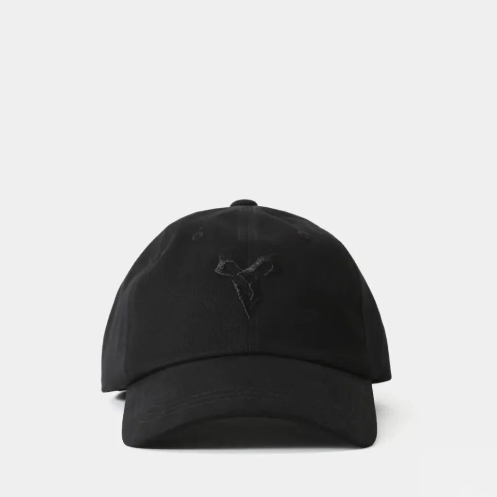 Minimalist black baseball cap embroidered with a subtle Final Fantasy X-inspired emblem on the front panel and tonal detailing along the curved brim