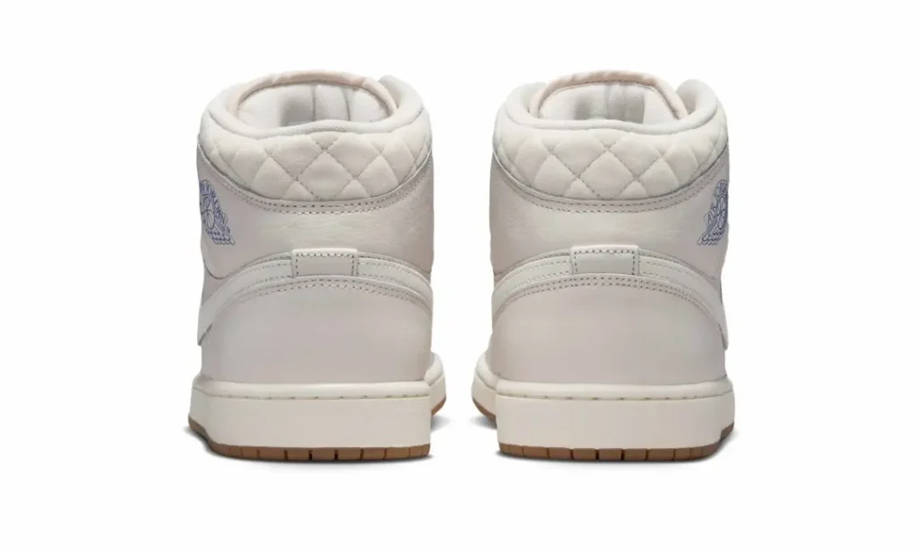 Rear view of the Air Jordan 1 Mid Premium highlighting the diamond-quilted collar construction, sail leather heel panels, and gum outsole edge