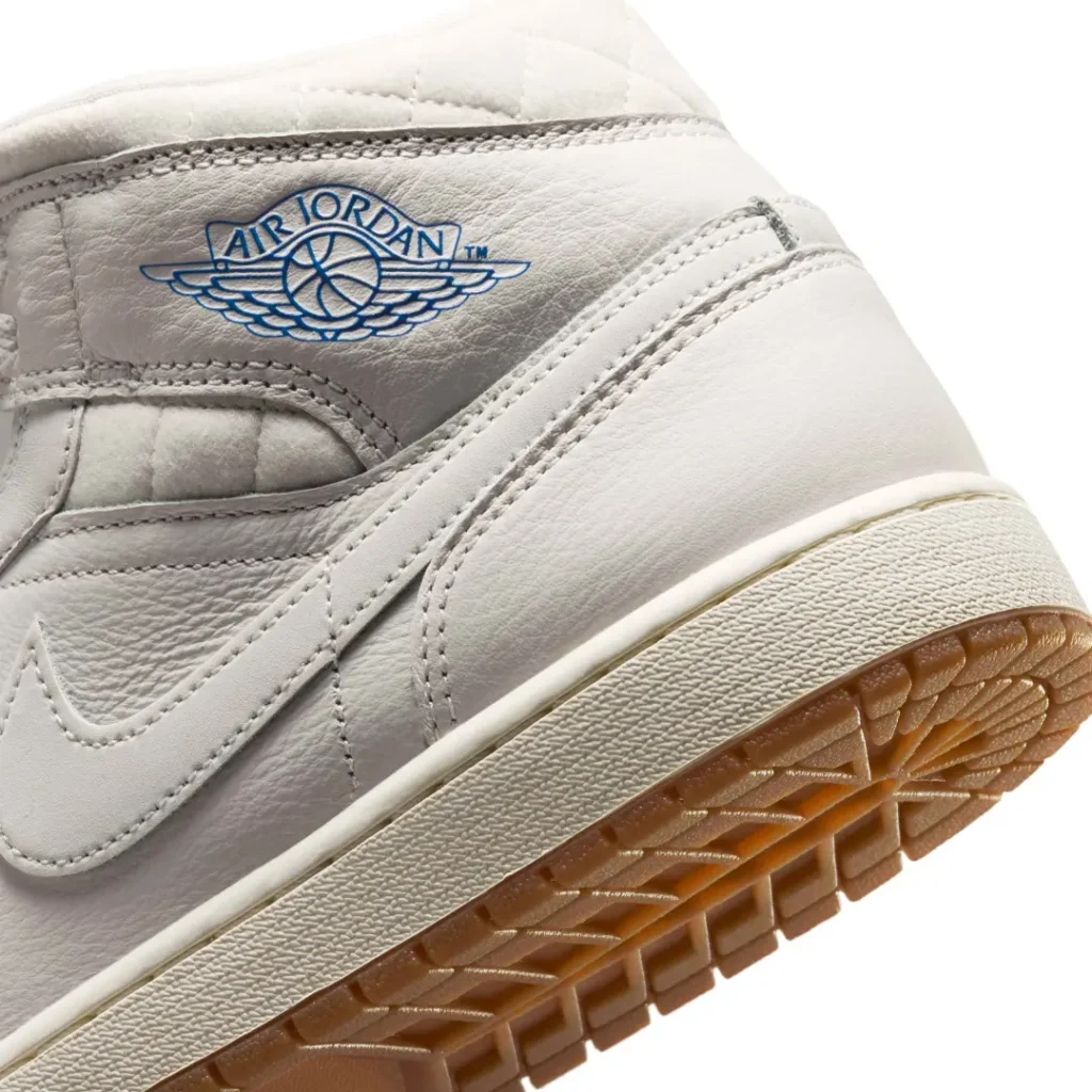 Detailed view of the Air Jordan Wings logo in blue on premium sail leather, paired with a textured cream midsole and translucent gum outsole