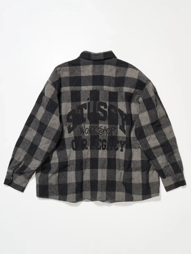 Grey-and-black checkered overshirt featuring tonal Stüssy and Our Legacy Workshop graphics printed across the back panel