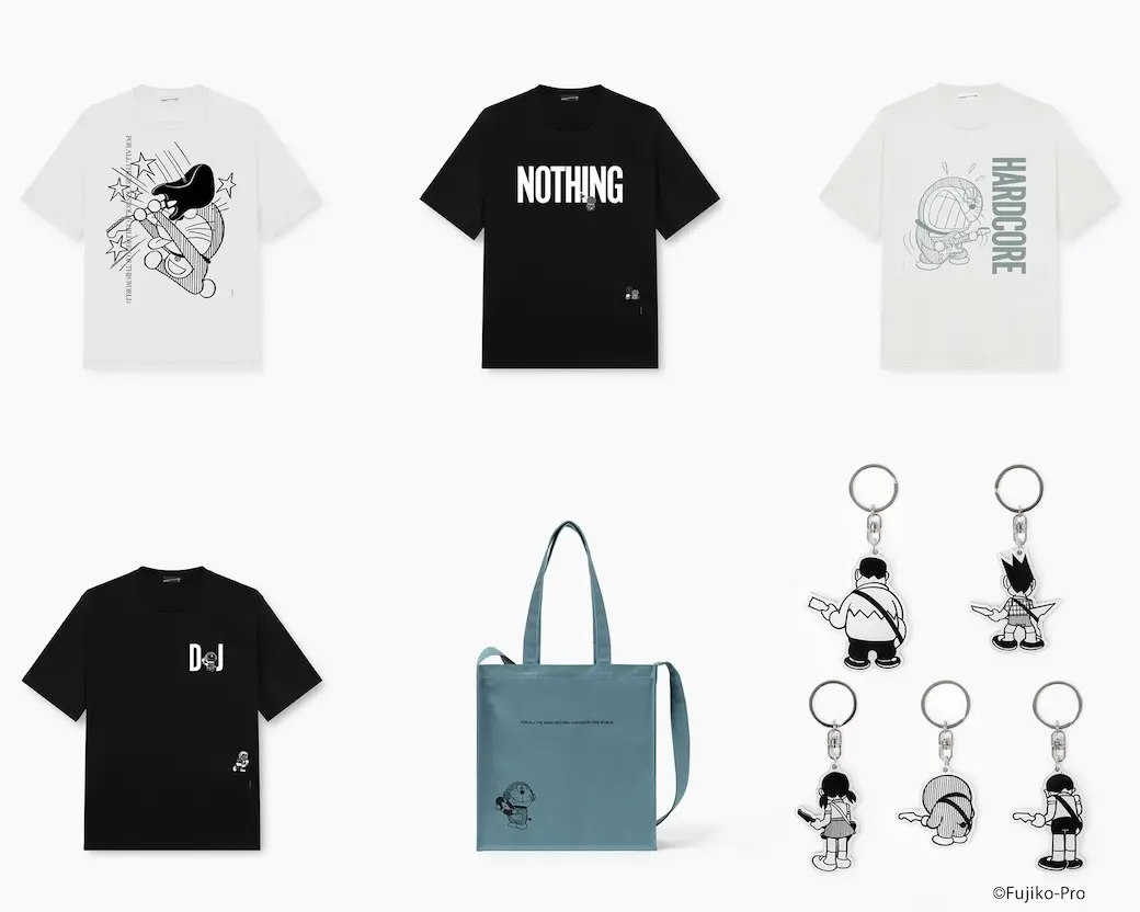 White oversized graphic Tee featuring the word “NOTHING” in bold black lettering across the chest, accented by a small monochrome Doraemon character integrated into the typography. Additional miniature character artwork appears near the lower hem, creating a minimalist manga-inspired design