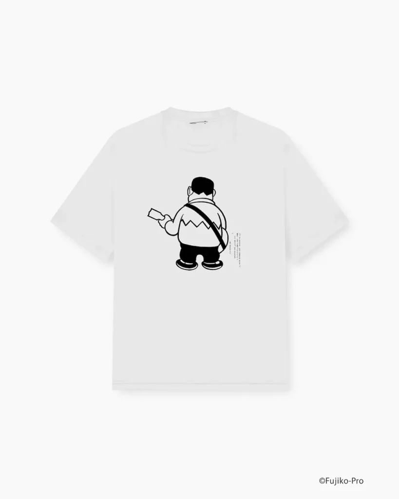 White oversized Tee featuring a monochrome back illustration of Nobita from Doraemon standing with his back turned and holding a gadget. The design is complemented by subtle vertical text elements for a modern graphic-streetwear look