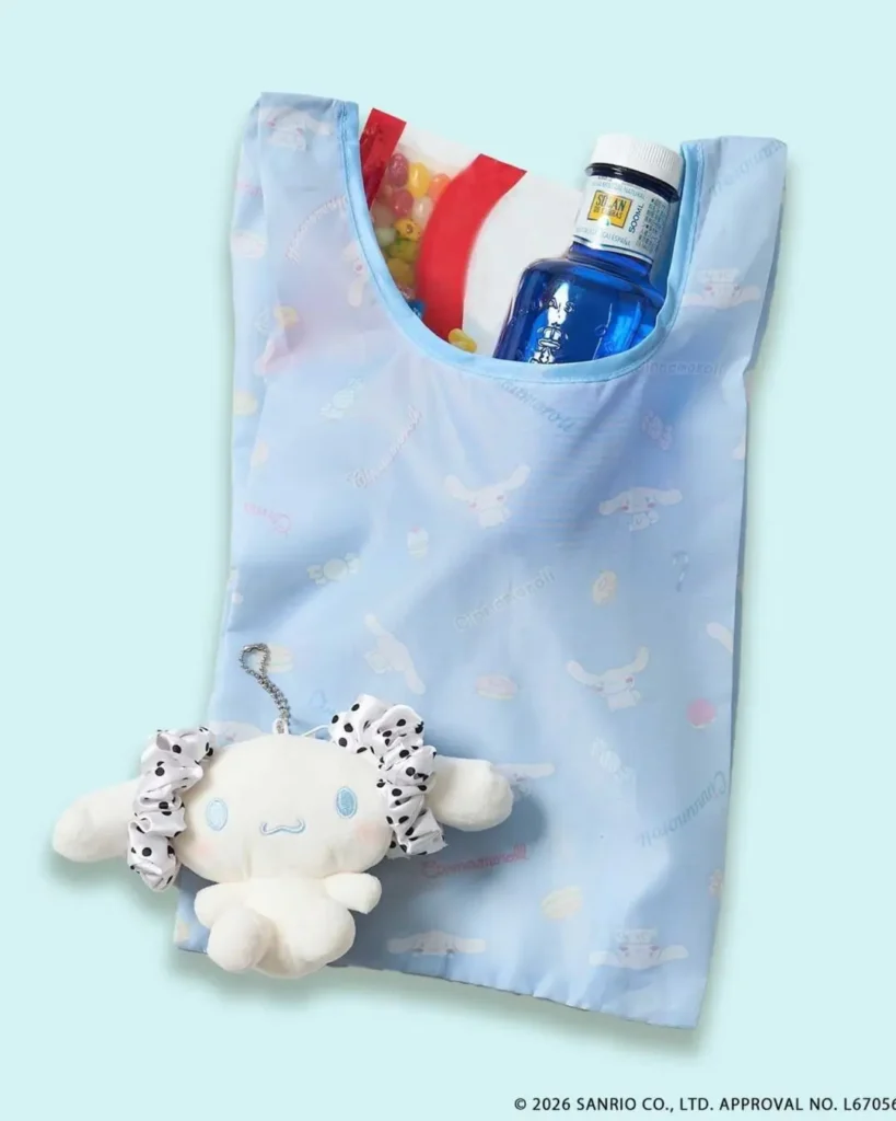 Light blue Cinnamoroll reusable tote bag decorated with pastel character graphics, paired with a matching plush charm and everyday carry item