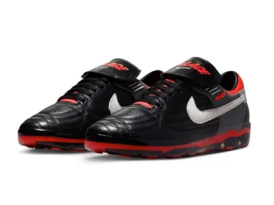 Angled pair shot of the PALACE x Nike CryoShot Air Speed M displaying quilted football-inspired leather panels, white Swooshes, red accents, and translucent CryoShot cushion