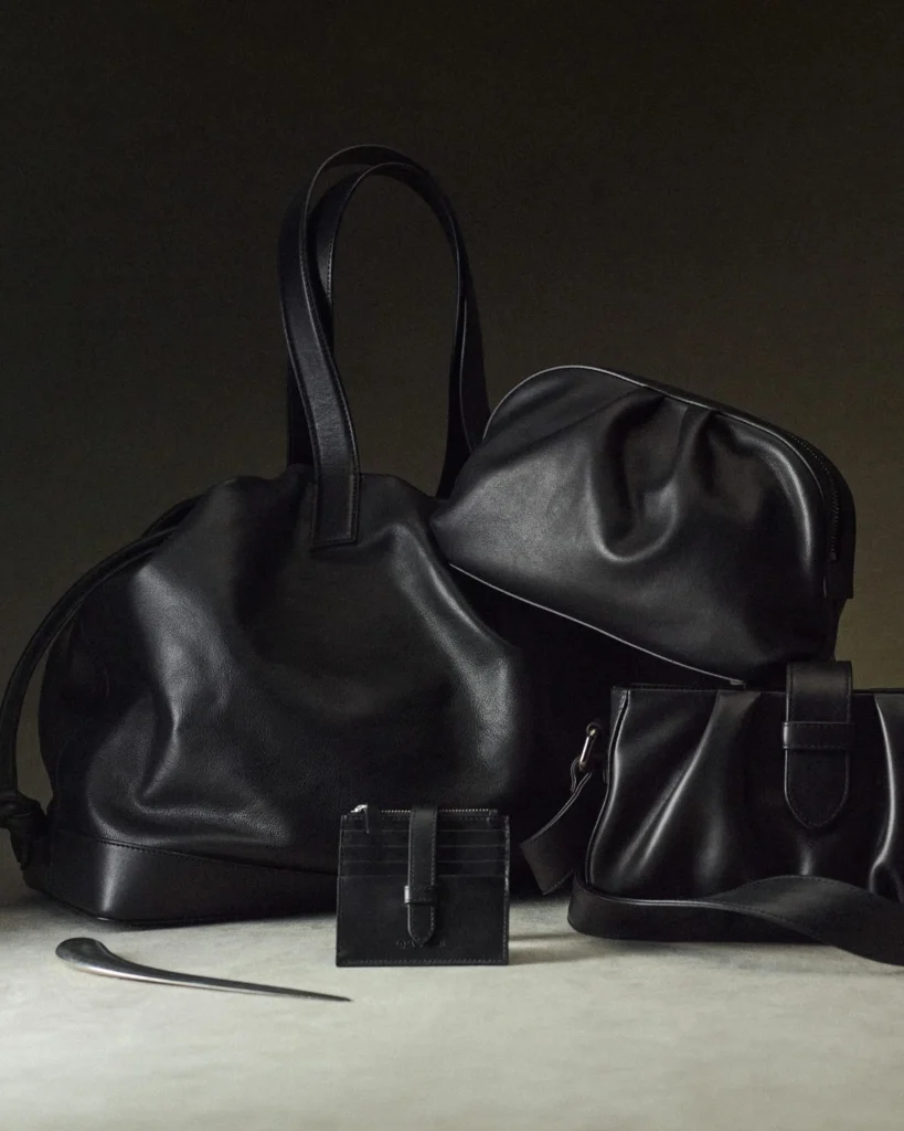 Coordinated collection of black and dark brown leather bags and accent