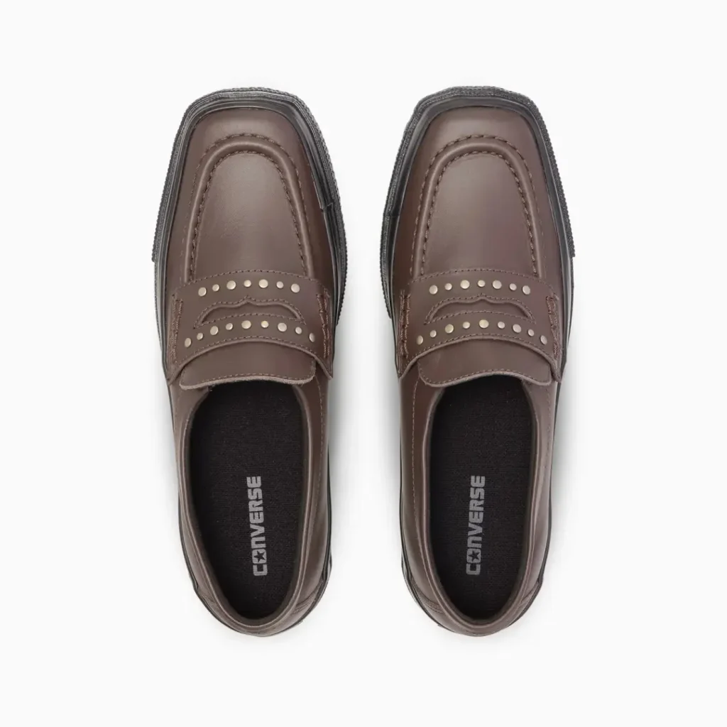 Top-down view of the brown Converse loafers showcasing the square toe, silver stud detailing, penny keeper, and Converse-branded black insole