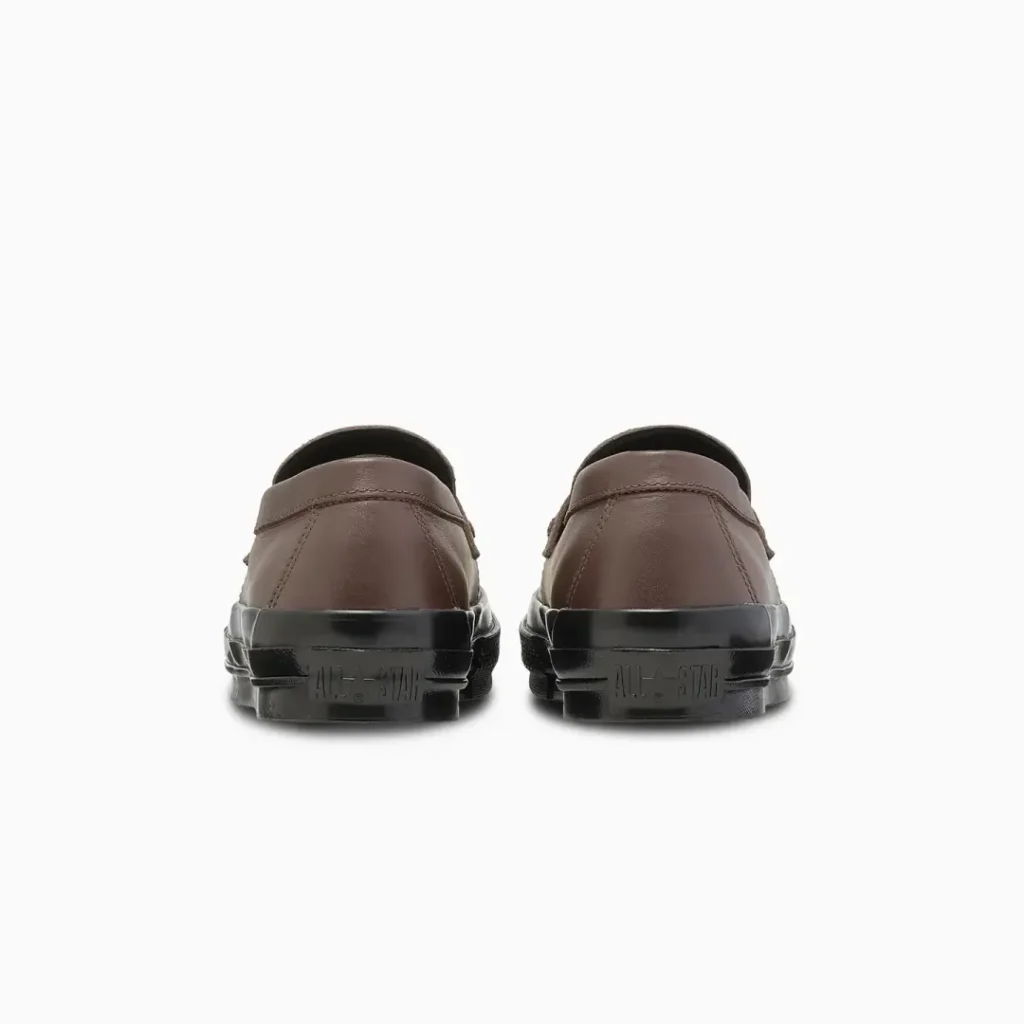 Rear view of the brown Converse loafers displaying embossed All Star branding on the black heel foxing and a clean leather heel panel
