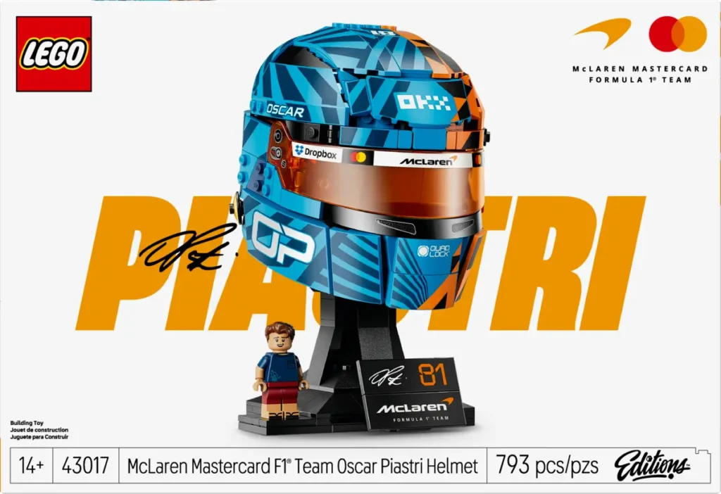 LEGO McLaren Formula 1 Team Oscar Piastri Helmet set box art featuring a detailed blue-and-orange brick-built racing helmet, display stand, signature plaque, and Oscar Piastri minifigure