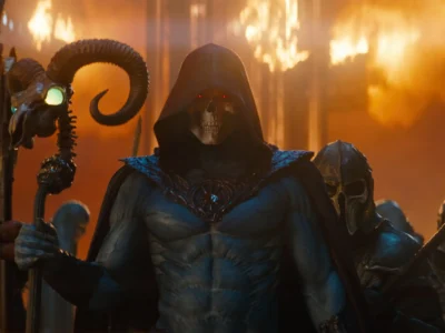 Skeletor stands at the center of a fiery battlefield in Masters of the Universe, wielding a ram-skull staff while surrounded by armored skeletal warriors, glowing red eyes piercing through the smoke and flames of Eternia's dark war-torn realm